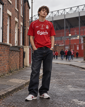 Liverpool 2004/05 home retro football shirt with Istanbul 2005 Champions League chest detail, modelled near Anfield