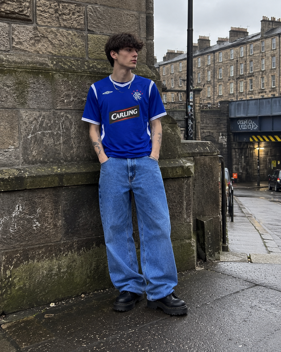 Model wearing Rangers 2005-06 blue Carling home shirt in gritty Glasgow street setting